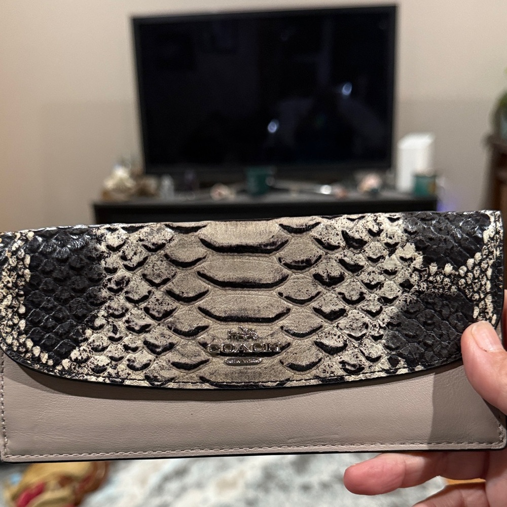 Coach Evie Long Wallet with a snakeskin print flap